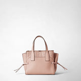Front view: SMALL MARO BAG IN CACHEMIRE LEATHER AND MOSAICO stands on a neutral background; antique rose, pebbled cachemire leather, knotted side straps, Mosaico panel on top, 'SERAPIAN' embossing.