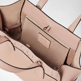 Detail view, SMALL MARO BAG IN CACHEMIRE LEATHER AND MOSAICO: opened interior shows soft Antique Rose cachemire leather, Mosaico structure, elegantly knotted nappa leather strips and interior pocket. Visible stamp: 'SERAPIAN MADE IN ITALY'.