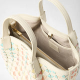 Detail view — MINI SECRET BAG IN MOSAICO MESTIERI D'ARTE: cream-coloured leather mini bag opened, showing a zippered pocket, an interior compartment and pastel mosaic triangles; visible lettering: 'SERAPIAN MILANO', 'SERAPIAN MADE IN ITALY'.