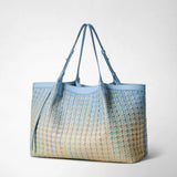 Frontal view: SECRET TOTE BAG IN MOSAICO MESTIERI D'ARTE shows a light blue-to-cream Bokashi gradient, a knotted mosaic pattern and elongated straps, freestanding against a neutral light-gray background.