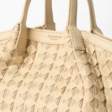 Detail view: MINI SECRET BAG IN RIBBON MOSAICO shows braided sand-colored Ribbon Mosaico with nappa leather bands and double handles; embossed 'SERAPIAN MILANO' lettering visible.