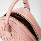 Detail view: PETRA HANDBAG IN MOSAICO in blush pink nappa leather, showing geometric woven pattern, top handle, and a partially opened gold zipper revealing the interior.