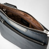 Detail view — FLAT CROSSBODY BAG IN STEPAN: Close-up shows open zippers, velvety brown interior lining and ocean-blue embossed Stepan exterior material; visible 'SERAPIAN MILANO' lettering.