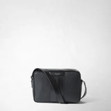 Frontal view: CAMERA CROSSBODY BAG IN STEPAN is placed on a light background; rectangular, black S-embossed Stepan canvas with leather bands and a wide shoulder strap across the front; inscription 'SERAPIAN MILANO'.