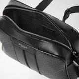 Detail view: CAMERA CROSSBODY BAG IN STEPAN, open bag with visible silver zipper, interior and embossed Stepan canvas on a light studio background. Visible lettering: "SERAPIAN MILANO".