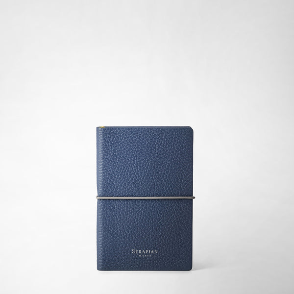 Front view: NOTEBOOK IN CACHEMIRE LEATHER in Avio Blue by Serapian, featuring smooth fine leather texture and elastic closure, white 'SERAPIAN MILANO' embossing at bottom.